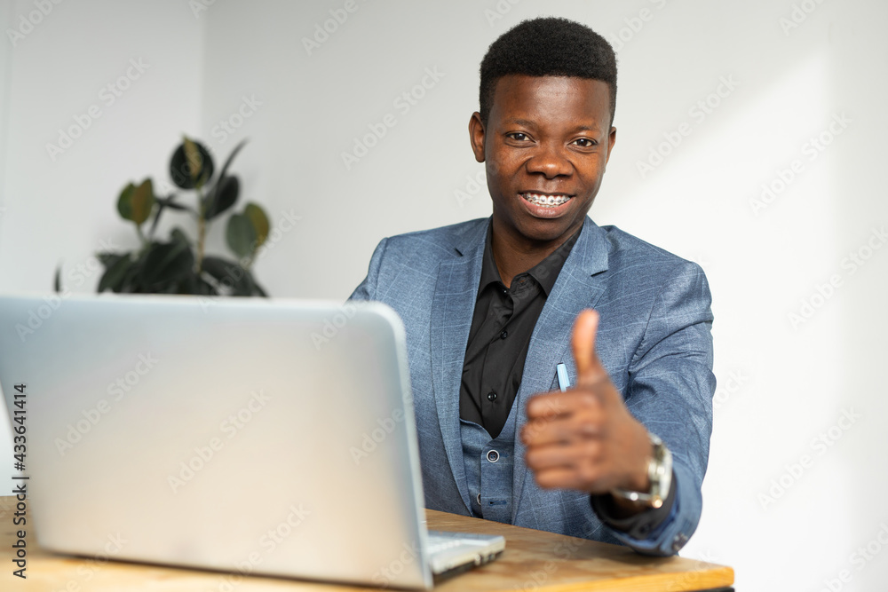 young african office worker with laptop with hand gesture young african office worker with laptop with hand gesture