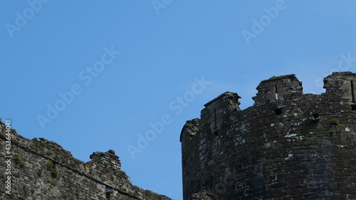 Blue sky above an old stone castle wall