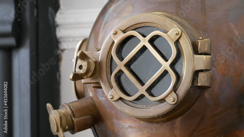 Close up of an old, bronze antique diving helmet
