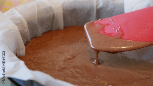 Chocolate cake batter mix on a spatula dripping off