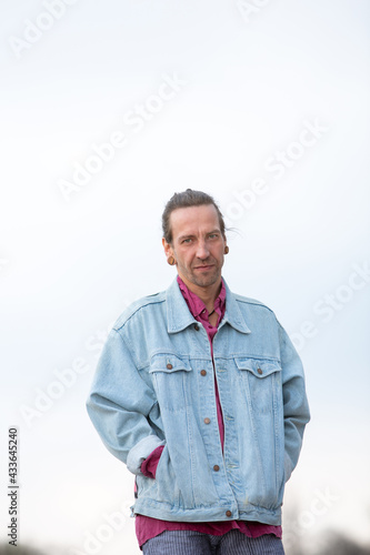 hipster with jeans jacket outdoors in the street