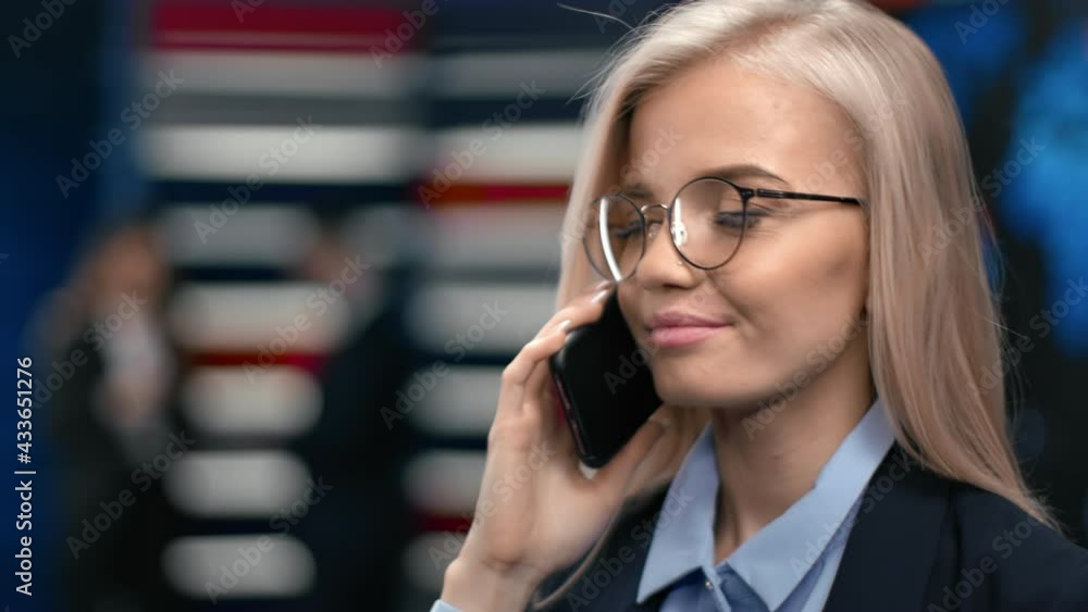 Close up face of blonde woman manager calling smartphone consulting deal profit at hi tech office Close up face of blonde woman manager calling smartphone consulting deal profit at hi tech office