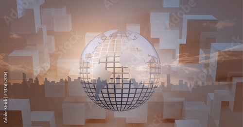 Composition of white globe over orange blocks and cityscape in background