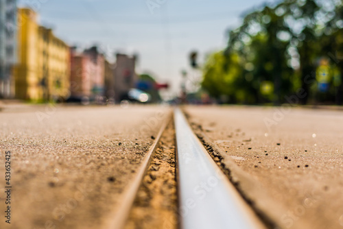 Summer in the city, the avenue. Close up view of a tram rail level