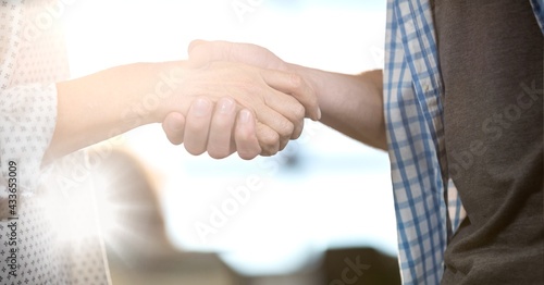 Composition of man and woman shaking hands