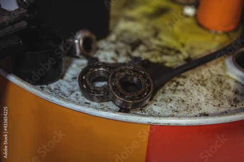 Close up of ball bearings lying on metal can in workshop photo