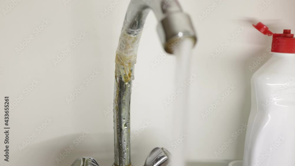 Rusty faucet rewound with tape leaks from rust close up Rusty faucet rewound with tape leaks from rust close up