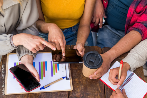 Close up Group Young Coworkers Together Discussing Creative Project During Work Process in start up studio.Friends Business Meeting Discussion in Office.Hands Typing pad.up view concept with no faces