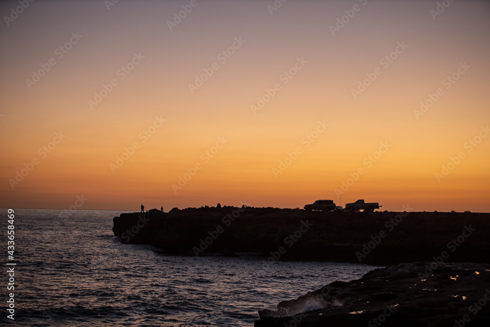 Sunrise golden sky silhouette view of people fishing Sunrise golden sky silhouette view of people fishing