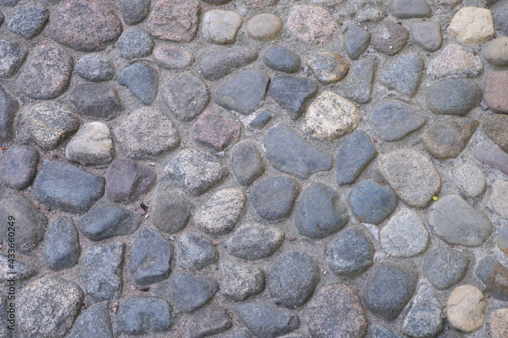 The texture of the old stone path. Suitable for backgrounds. The texture of the old stone path. Suitable for backgrounds.