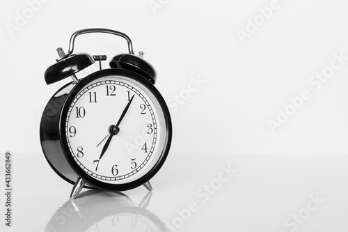 Classic black alarm clock on white background. Time concept.