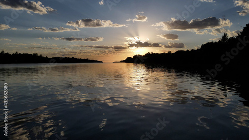 Amazing sunset in Amazon River with waves and sky reflected on the water