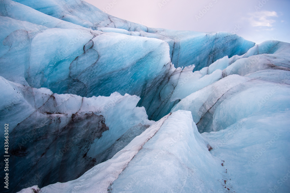 Detail Icelandic glacier image bright blue glacier abstract closeup texture image with black lines from volcanic ash Detail Icelandic glacier image bright blue glacier abstract closeup texture image with black lines from volcanic ash