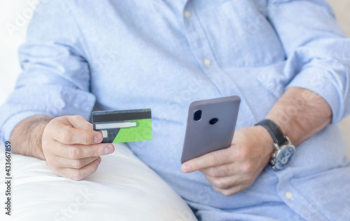 Man holding credit card and phone. Online shopping. Online banking concept.