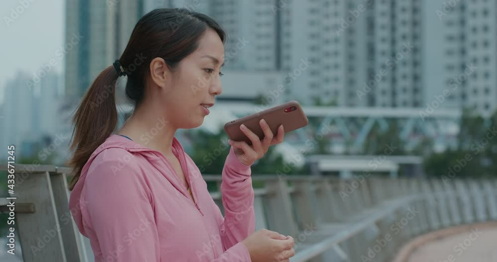 Woman send audio message on cellphone at outdoor Woman send audio message on cellphone at outdoor