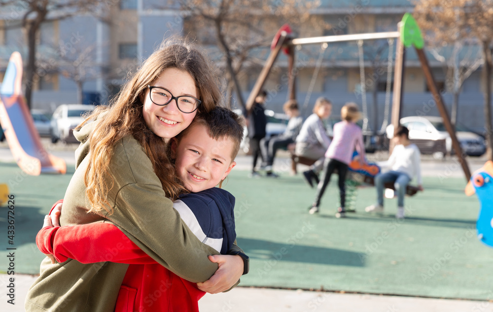 Portrait of brother and sister at the playground. High quality photo