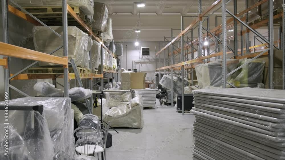 corridor filled with stacks of details and assembled items at furniture production storage. industrial storehouse corridor filled with stacks of details and assembled items at furniture production storage. industrial storehouse