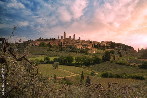 medieval town of san gimignano surrounded by green tuscan vineyards