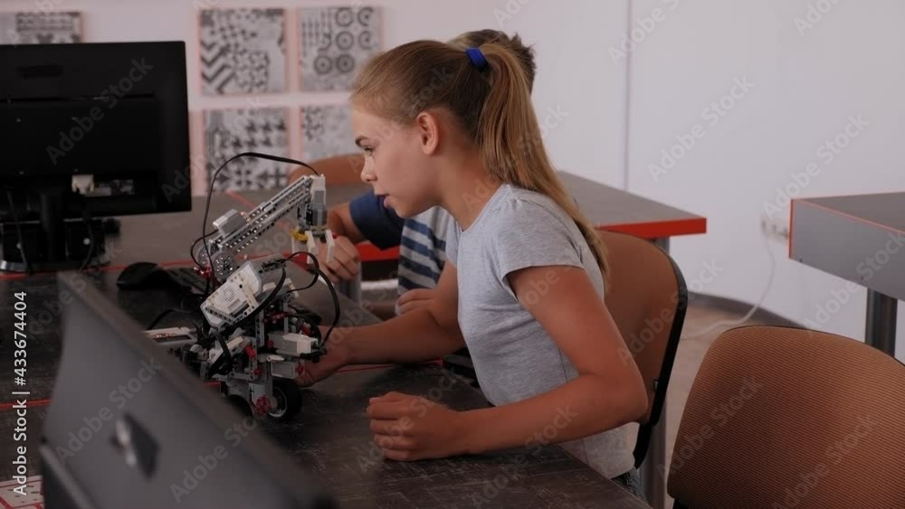 Group of children are making robots from the constructor in School of Robotics. Group of children are making robots from the constructor in School of Robotics.