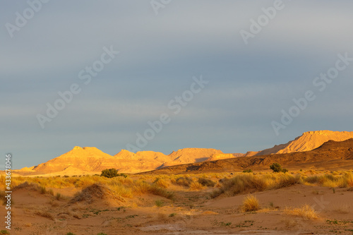 Sunset in the Sahara Desert. Mountains in the rays of the setting sun. Morocco © Mieszko9