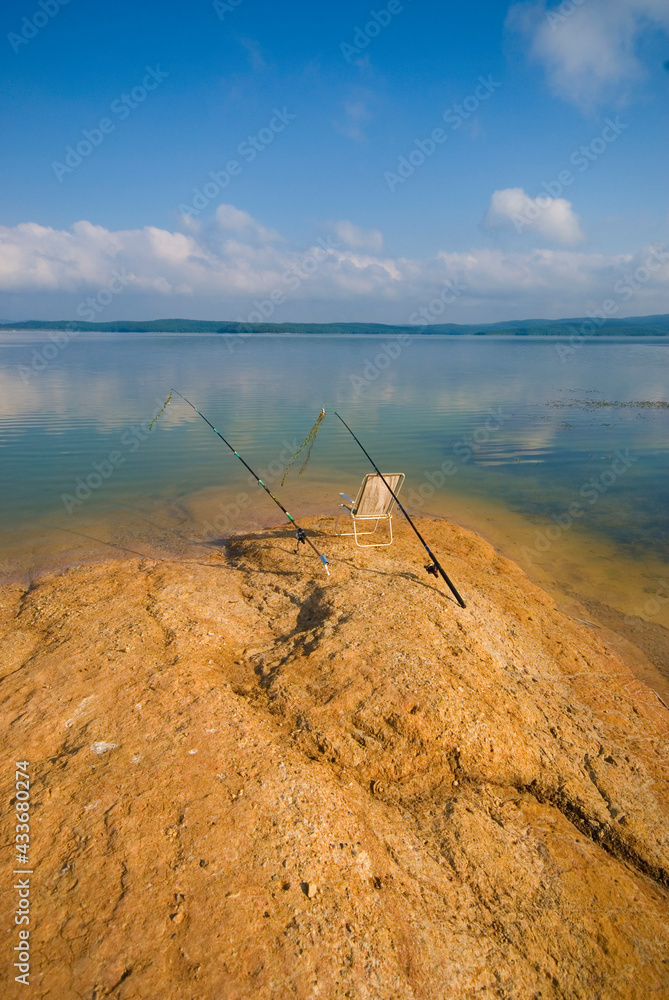 Fototapeta premium Fishing with rod on lake.Two fishing rods on the background of the lake. 