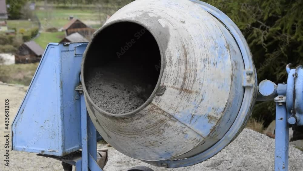 Mixing cement in a concrete mixer Mixing cement in a concrete mixer