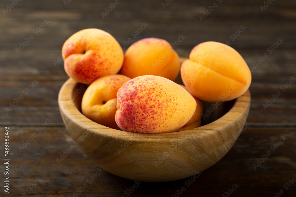 Fresh apricots in a wooden plate. Fresh apricots in a wooden plate.