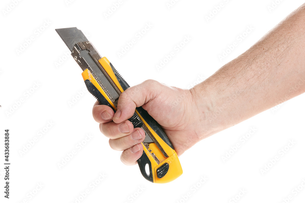 Hand holds a construction knife on a white background, a template for designers. Hand holds a construction knife on a white background, a template for designers.