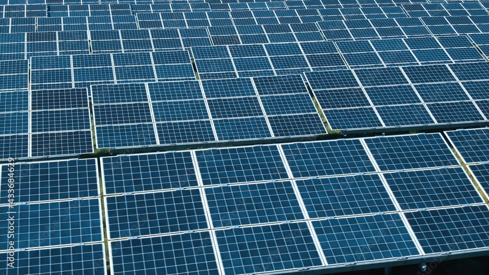 Aerial view of Solar Panels Farm solar cell with sunlight. Drone flight over solar panels field, renewable green alternative energy concept Aerial view of Solar Panels Farm solar cell with sunlight. Drone flight over solar panels field, renewable green alternative energy concept