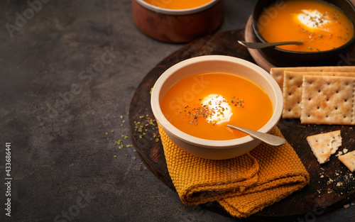 Delicious plates of creamy pumpkin soup seen from above