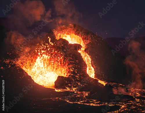 Close-up Fagradalsfjall volcano erupting in Iceland between clouds of smoke