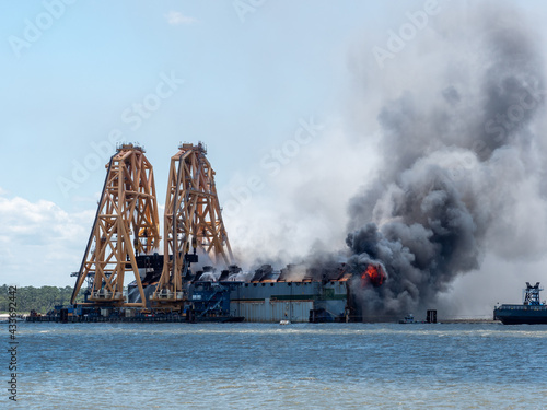 St Simons Island, GA USA - May 14 2021: Fire breaks out during demolition of Golden Ray cargo ship in the St. Simons Sound