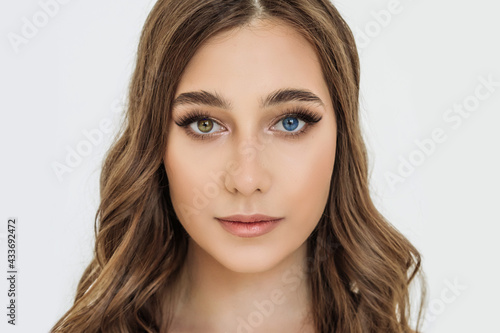 heterochromia in an attractive Caucasian young woman. face close-up, portrait of a beautiful woman with eyes of different colors of blue and brown. melanin, genetics photo