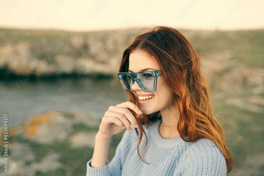 cute red-haired woman wearing glasses outdoors fresh air travel