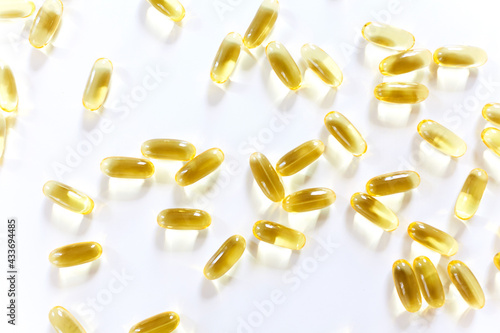 Omega 3 capsules lying on white background. Fish oil in pills. Health support and treatment. Biologically active additives. Selective focus.
