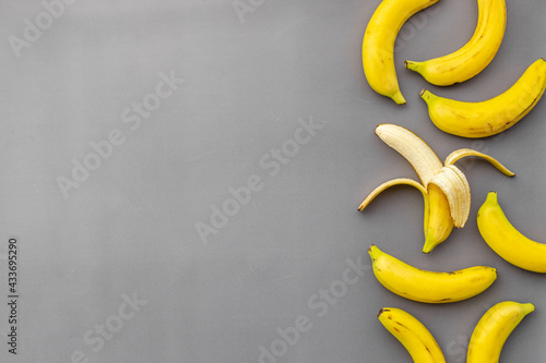 Whole and peeled bananas flay lay. Fruits pattern. Top view