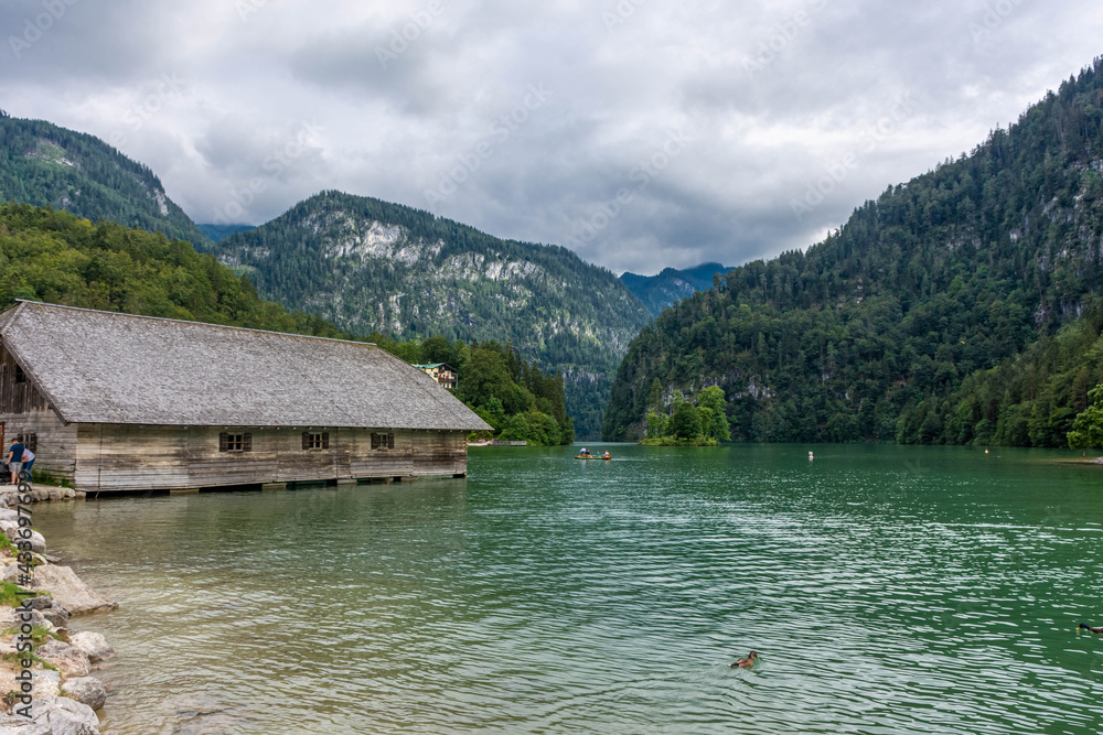 KONIGSEE, GERMANY, 3 AUGUST 2020: Wooden houses on the banks of Konigsee Lake KONIGSEE, GERMANY, 3 AUGUST 2020: Wooden houses on the banks of Konigsee Lake