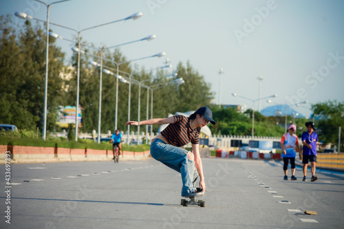 Young woman play surfskate at bridge along the seashore, Chonburi , Thailand