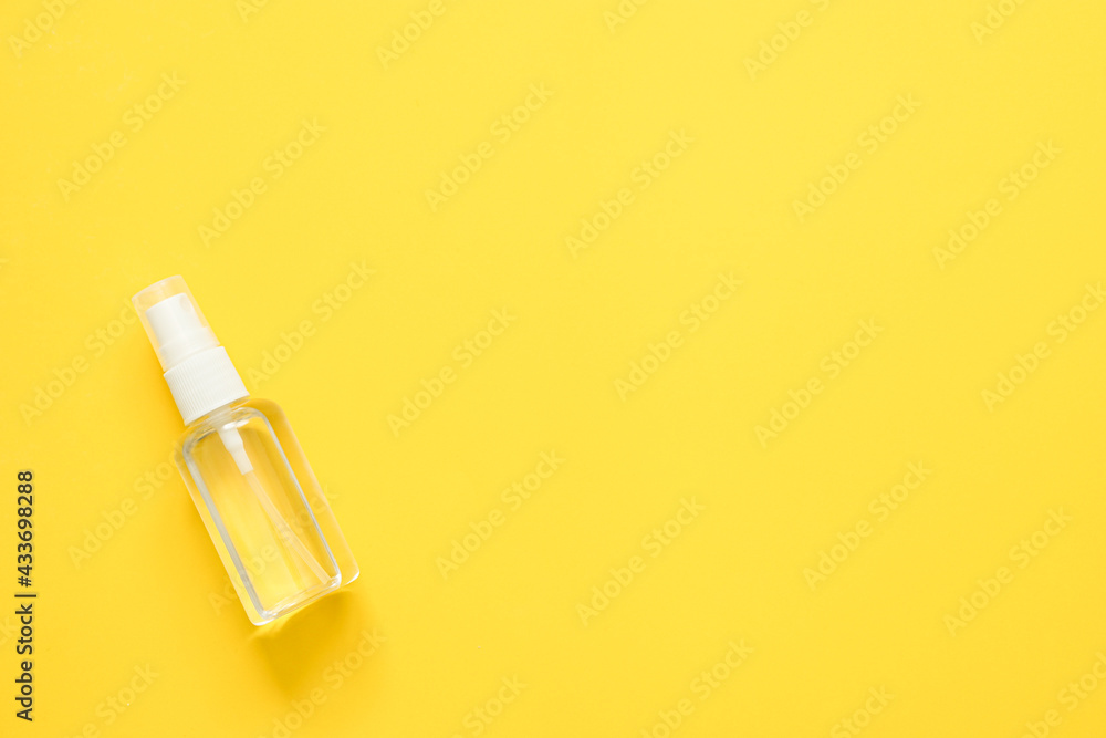 top view of alcohol spray in transparent plastic bottle on yellow background, Coronavirus protection equipment background concept. top view of alcohol spray in transparent plastic bottle on yellow background, Coronavirus protection equipment background concept.