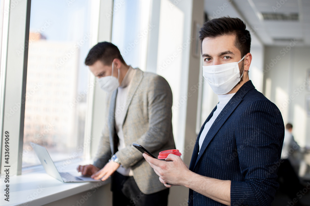 Businessmen wearing a face masks are negotiating. New normal after Covid-19 Corona virus pandemic. Businessmen wearing a face masks are negotiating. New normal after Covid-19 Corona virus pandemic.