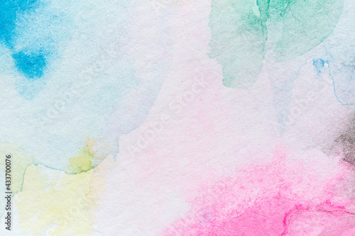 Macro close-up of an abstract colorful watercolor gradient fill background with watercolour stains. High resolution full frame textured white paper background.