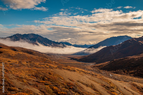 dramatic landscape of mountain peaks and mountain ranges inside Denali National Park during autumn season.