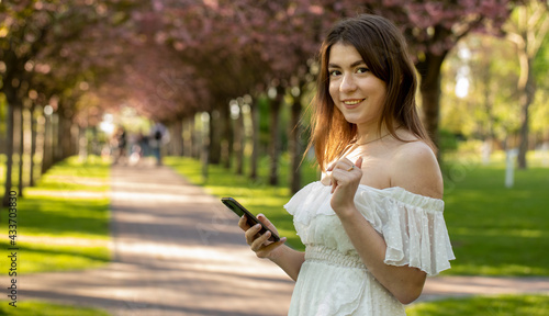 Attractive girl talking on the phone in the park