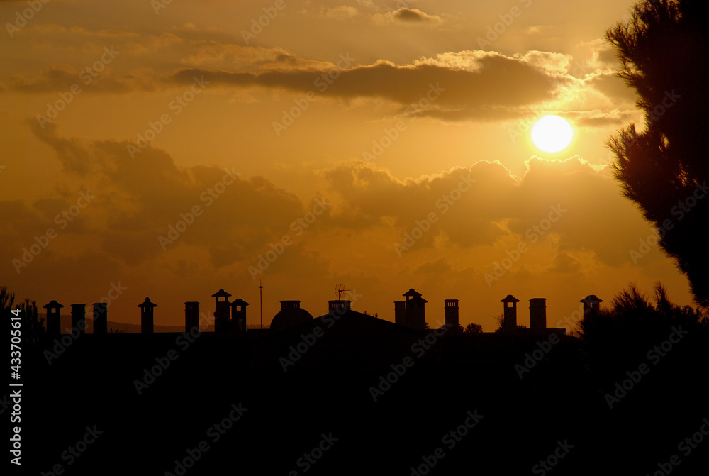 silhouette of cityscape on sunset