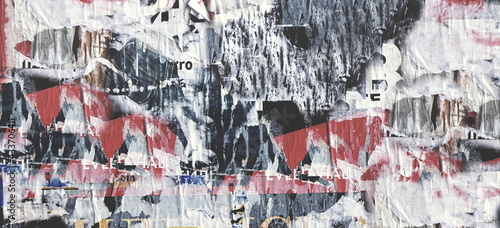 Scratched Advertising On Grunge Wall Panoramic Rough Background. Exposed Weathered Urban Wall with Torn Street Posters, Paper and Stickers. Vintage Billboard With Torn Poster, Paper, Ads 