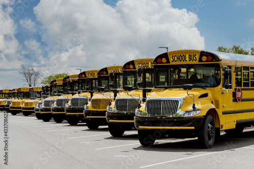 Yellow school bus for children educational transport on the street photo