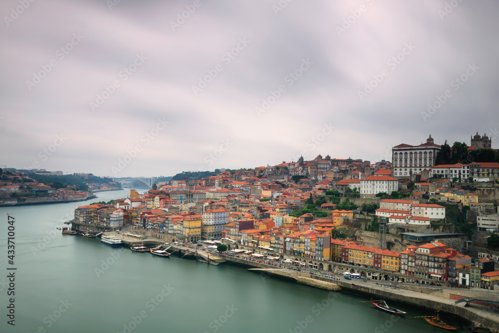 Naklejka premium Oporto, Portugal, Europe. Postcard from the picturesque city of Porto, amazing travel destination in Portugal. View to the historic center of the city, Douro River with its beautiful bridge