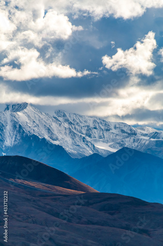 dramatic autumn landscape of snowcapped mountain ranges and peaks inside DEnali National park . © Nathaniel Gonzales