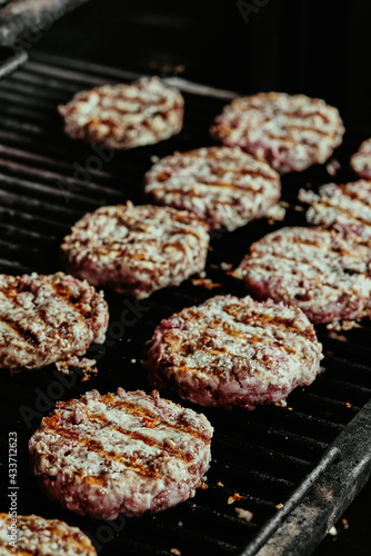 burger cutlets on a grill - cutlets made from organic beef. raw cutlets