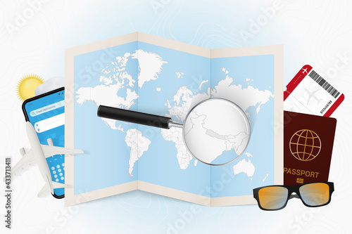 Travel destination Nepal, tourism mockup with travel equipment and world map with magnifying glass on a Nepal.